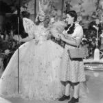 1939 MGM promotional photograph of Billie Burke as Glinda and Judy Garland as Dorothy in The Wizard of Oz.