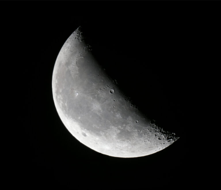 Detailed telescopic mosaic of the waning crescent Moon with sharp crater detail along the illuminated crescent.