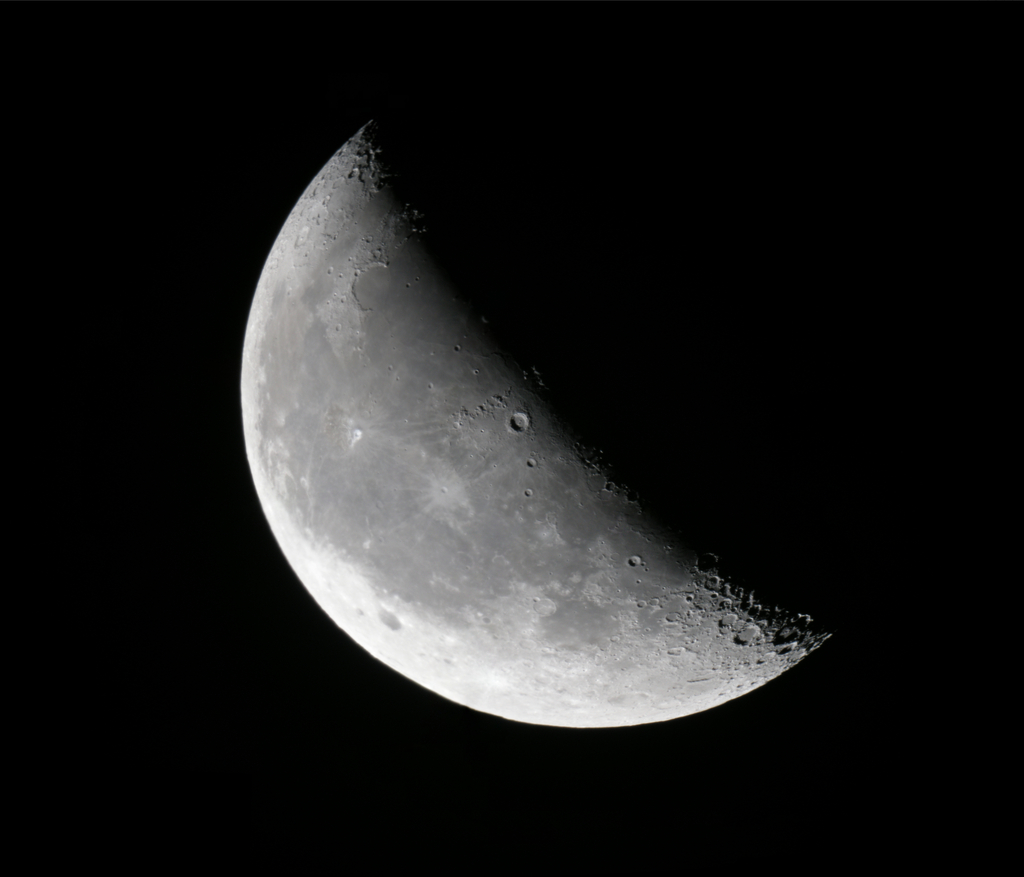 Detailed telescopic mosaic of the waning crescent Moon with sharp crater detail along the illuminated crescent.